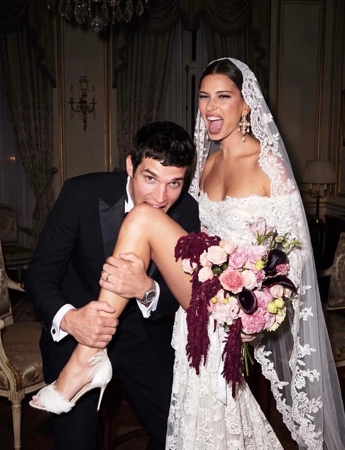 A newly married couple celebrating with a bouquet of flowers
